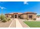 Single-story home with stone accents and a landscaped front yard at 6786 W Gelding Ln, Coolidge, AZ 85128