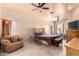 Spacious bedroom with a king-size bed, ceiling fan, and tiled floor at 6786 W Gelding Ln, Coolidge, AZ 85128