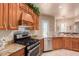 View of kitchen range, cabinets and double sink at 6786 W Gelding Ln, Coolidge, AZ 85128