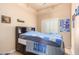 Bright bedroom with double bed, dresser, and large window at 6786 W Gelding Ln, Coolidge, AZ 85128