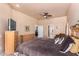 Primary bedroom with king bed, dresser, and access to another room at 6786 W Gelding Ln, Coolidge, AZ 85128