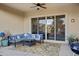 Relaxing covered patio with seating and outdoor rug at 41650 W Harvest Moon Dr, Maricopa, AZ 85138