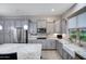 Modern kitchen featuring granite countertops, stainless steel appliances, and ample cabinetry at 41650 W Harvest Moon Dr, Maricopa, AZ 85138
