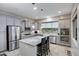 Modern kitchen with granite island and stainless steel appliances at 41650 W Harvest Moon Dr, Maricopa, AZ 85138