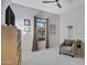 Bright bedroom with window, chair, and built-in shelving at 41650 W Harvest Moon Dr, Maricopa, AZ 85138