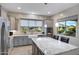 Modern kitchen with granite island and farmhouse sink at 41650 W Harvest Moon Dr, Maricopa, AZ 85138