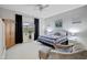 Cozy bedroom with a queen-size bed, large window, and wood armoire at 41650 W Harvest Moon Dr, Maricopa, AZ 85138