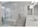 Spa-like bathroom with a walk-in shower, built-in bench and modern fixtures at 41650 W Harvest Moon Dr, Maricopa, AZ 85138