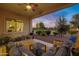 Spacious patio with furniture and view of the sunset at 41650 W Harvest Moon Dr, Maricopa, AZ 85138