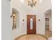 Elegant entryway with arched details, a wood door, and a circular tile floor at 31811 N 16Th Ave, Phoenix, AZ 85085