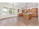 Gourmet kitchen boasts wood cabinetry, granite island, and breakfast nook at 31811 N 16Th Ave, Phoenix, AZ 85085