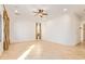 Spacious living room with tile floors, large windows, and ceiling fan at 31811 N 16Th Ave, Phoenix, AZ 85085