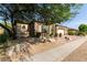 Landscaped front yard with mature tree and desert plants at 31811 N 16Th Ave, Phoenix, AZ 85085