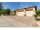 Three-car garage with tan stucco exterior and pavers at 31811 N 16Th Ave, Phoenix, AZ 85085