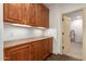 Laundry room with ample wood cabinets and counter space at 31811 N 16Th Ave, Phoenix, AZ 85085