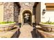 Elegant entryway with stone arch, wrought iron gate, and large planters at 31811 N 16Th Ave, Phoenix, AZ 85085