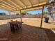 Patio with table and chairs, adjacent to grassy backyard at 2057 E Howe Ave, Tempe, AZ 85281