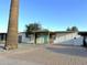 Ranch style home with teal door, covered porch, and spacious driveway at 2057 E Howe Ave, Tempe, AZ 85281