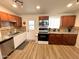 Updated kitchen with wood cabinets, granite counters, and breakfast bar at 2057 E Howe Ave, Tempe, AZ 85281