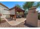 Backyard patio with pergola, seating, and fire pit at 273 W Hawthorne Dr, Casa Grande, AZ 85122