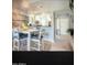 Bright dining area with beach mural and modern table set at 7101 W Beardsley Rd # 452, Glendale, AZ 85308