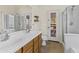 Double sinks, garden door, shower, and tub in this bright bathroom at 15890 W Diamond St, Goodyear, AZ 85338