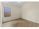 Simple bedroom with wood-look floors and a window at 15890 W Diamond St, Goodyear, AZ 85338