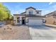 Two-story house with a two-car garage and desert landscaping at 24795 W Jones Ave, Buckeye, AZ 85326