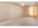 Spacious bedroom with carpeted floors and ceiling fan at 23780 W Tonto St, Buckeye, AZ 85326