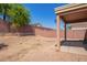 Covered patio and gravel backyard with block wall at 23780 W Tonto St, Buckeye, AZ 85326