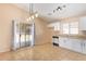 Kitchen features white cabinets, tile floors, and access to backyard at 23780 W Tonto St, Buckeye, AZ 85326