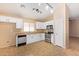 Kitchen with white cabinets, stainless steel appliances, and tile floor at 23780 W Tonto St, Buckeye, AZ 85326