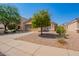 One-story house with a tan stucco exterior, double-car garage, and a small front yard at 23780 W Tonto St, Buckeye, AZ 85326