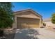 Tan stucco house with a double-car garage and a small front yard at 23780 W Tonto St, Buckeye, AZ 85326
