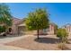 One-story house with a tan stucco exterior, double-car garage, and a small front yard at 23780 W Tonto St, Buckeye, AZ 85326