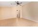 Bright living room with tile floors and ceiling fan at 23780 W Tonto St, Buckeye, AZ 85326