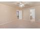 Bedroom with carpet, ceiling fan, and access to bathroom at 23780 W Tonto St, Buckeye, AZ 85326