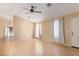 Bright living room with tile floors, ceiling fan, and access to other rooms at 23780 W Tonto St, Buckeye, AZ 85326