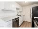 Modern kitchen with white cabinets and stainless steel appliances at 4015 S 45Th St, Phoenix, AZ 85040