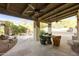 Covered patio with seating area, ceiling fan, and view of a tranquil courtyard at 4754 E Valley Vista Ln, Paradise Valley, AZ 85253