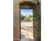 Rustic wooden gate opens to a charming courtyard with desert plants at 4754 E Valley Vista Ln, Paradise Valley, AZ 85253