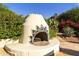 Outdoor fireplace nestled in a beautifully landscaped garden at 4754 E Valley Vista Ln, Paradise Valley, AZ 85253