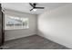 Bedroom with wood-look floors, ceiling fan, and barn door closet at 6131 E Monterey Way, Scottsdale, AZ 85251