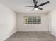 Bedroom with wood-look floors, ceiling fan and backyard view at 6131 E Monterey Way, Scottsdale, AZ 85251