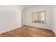 Well-lit bedroom featuring wood floors and large window at 16839 E Widgeon Ct, Fountain Hills, AZ 85268