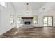 Living room with fireplace, wood-look floors, and lots of light at 16839 E Widgeon Ct, Fountain Hills, AZ 85268