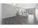 Open concept living and kitchen area with grey wood-look flooring at 10347 N 115Th Ave, Youngtown, AZ 85363
