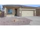 Single-story home with beige exterior, two-car garage, and landscaping at 10347 N 115Th Ave, Youngtown, AZ 85363
