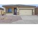 House exterior with a two-car garage and stone accents at 10347 N 115Th Ave, Youngtown, AZ 85363