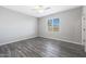 Spacious bedroom with ceiling fan and grey wood-look flooring at 10347 N 115Th Ave, Youngtown, AZ 85363